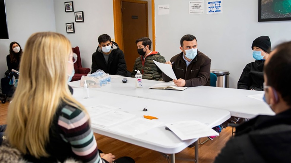 Alexandria Nylen (left), a civil-military program coordinator at Brown, is conducting a months-long series of interviews with several Afghans at the Refugee Dream Center in Providence.