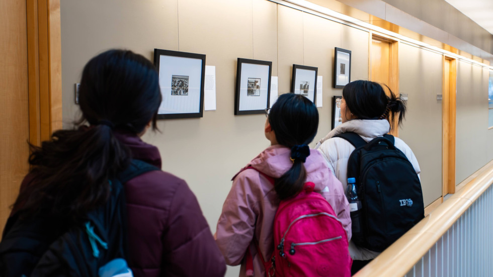 Three people viewing exhibition