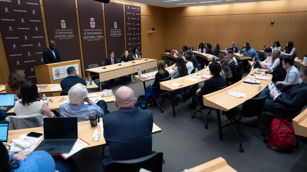 David Blanding at the podium during the PIA Symposium, while Ryan Zapata, Olivia Hayes and Lailah Williams take questions from the audience. 