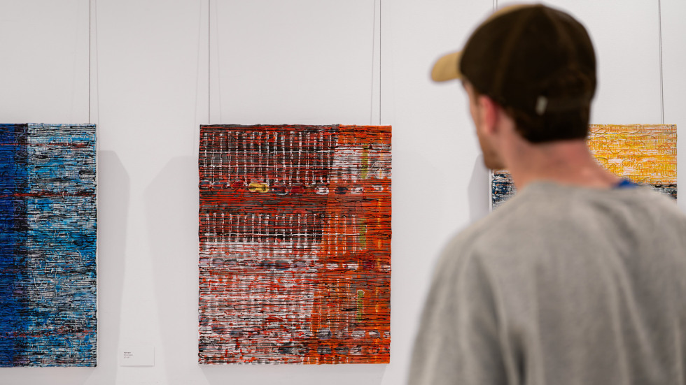 Person looking at paintings